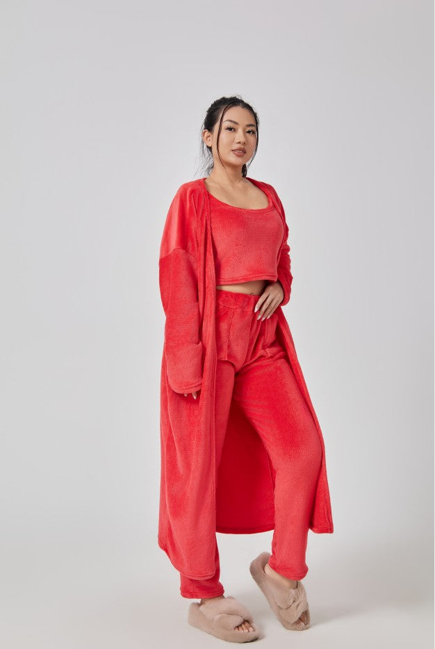 Woman wearing a red outfit with a long duster on a white background