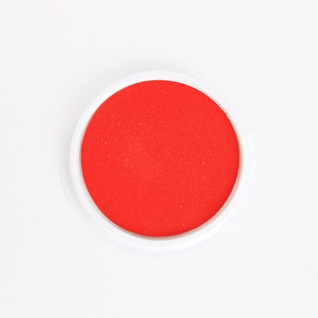 Red circular object on a white background