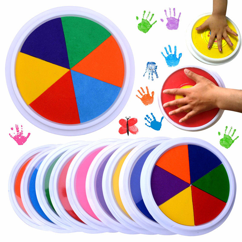 Colorful spinning tops with hand prints and a child's hand interacting with one of them on a white background.