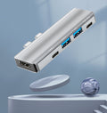 Laptop with 5-in-1 aluminum USB-C multimedia hub featuring 4K HDMI port and multiple data transfer options.