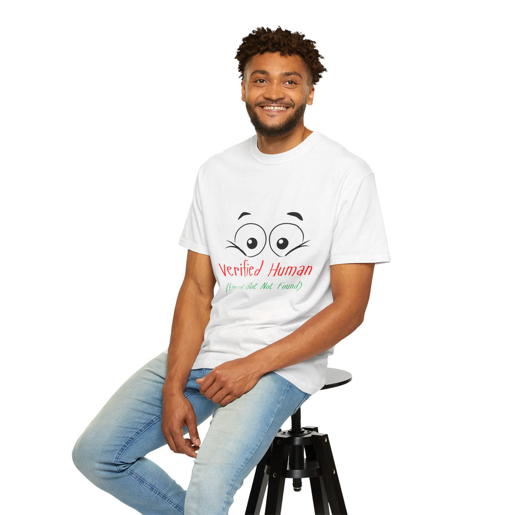 Man sitting on a stool wearing a white t-shirt with a small logo and light blue jeans.