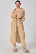 Woman wearing a beige outfit with a matching cardigan on a white background