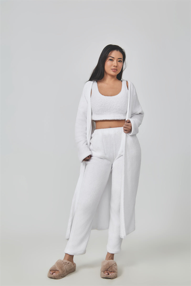Woman wearing a white outfit on a plain background